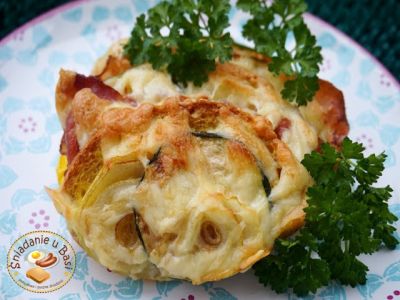 Casserole with stale bread with zucchini and crispy bacon